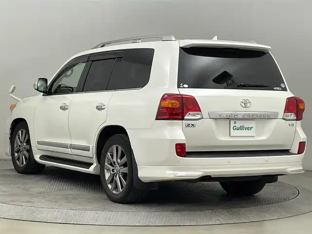 トヨタ ランドクルーザー ZX ブルーノクロス 道央・札幌 2015(平27)年 12.1万km ホワイトパールクリスタルシャイン ・ワンオーナー/・４WD/・純正HDDナビゲーション/　CD/DVD/HDD/BT/フルセグ/AUX/USB/・モデリスタエアロ（F・S・R）/・サンルーフ/・パワーバックドア/・スマートキー/・プッシュスタート/・保証書あり/・取説あり/・MTモード付AT/・クルーズコントロール/・横滑り防止装置/・前後コーナーセンサー/・全席パワーシート/・レザーシート/・前席シートヒーター/エアシート/・ステアリングヒーター/・ハイトコントロール/・電動格納サードシート/・純正フロアマット/・純正AW20インチ/・ダウンヒルアシストコントロール/・LEDヘッドライト/・フロントフォグランプ/・オートライト/・社外AW18インチスタッドレス積込/・センターコンソールクールボックス
