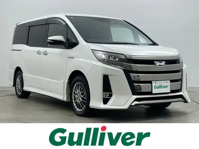 トヨタ ノア ハイブリッド Si ダブルバイビーⅡ 岡山県 2019(令1)年 6.2万km ホワイトパールクリスタルシャイン 純正9型ナビ（NSZT-Y68T）/【フルセグTV/CD/DVD/BT】/バックカメラ/純正12.1インチフリップダウンモニター/両側パワースライドドア/トヨタセーフティセンス/クルーズコントロール/ビルトインETC/ステアリングリモコン/ハーフレザーシート/D/Nシートヒーター/LEDオートライト/フォグランプ/スマートキー/プッシュスタート/フロアマット/純正ドアバイザー