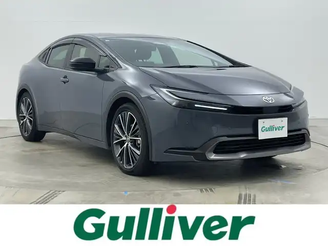 トヨタ プリウス G 岡山県 2025(令7)年 1万km グレー カラーコード：1M2/純正ディスプレイオーディオ/地デジ/Bluetooth/AppleCarPlay/バックカメラ/ブラインドスポットモニター/AC100V/シートヒーター/セーフティセンス /・プリクラッシュセーフティ/・レーンキープアシスト/・オートハイビーム/レーダークルーズコントロール/LEDヘッドライト/コーナーセンサー /オートライト/プッシュスタート /スマートキー