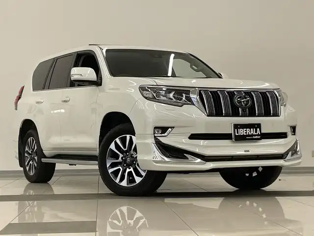 トヨタ ランドクルーザー プラド TZ－G 岡山県 2022(令4)年 2.7万km ホワイトパールクリスタルシャイン モデリスタエアロ/サンルーフ/トヨタセーフティセンス/・衝突軽減ブレーキ/・車線逸脱警報（レーンキープアシスト）/・オートマチックハイビーム/・レーダークルーズコントロール/・ブラインドスポットモニター/純正ナビ（T-Connect)/フルセグTV（AM.FM.TV.BT）/４WD/全方位カメラ/パワーシート（D+N席）/シートヒーター（D+N席）/シートエアコン（D+N席）/センターデフロック/サイドステップ/ヒルディセントコントロール/電動コラム/ETC2.0/アイドリングストップ/１９インチ純正AW/純正フロアマット