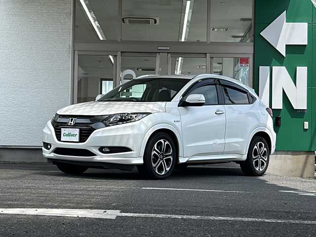 ホンダ ヴェゼル ハイブリッド Z 愛知県 2014(平26)年 8.4万km ホワイトオーキッドパール 禁煙車/ワンオーナー/純正インターナビ/ハーフレザーシート/寒冷地仕様/クルーズコントロール/パドルシフト/バックカメラ/パーキングアシスト/フルセグ/Bluetooth/ステアリングリモコン/HDMI/BREAKHOLD/シートヒーター（D/N席）/ECON/オートライト/フォグランプ/ドアバイザー/純正アルミ/純正フロアマット/ETC/スペアキー/取扱説明書/保証書