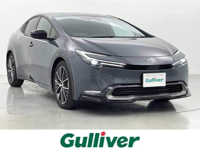 トヨタ プリウス Z 熊本県 2025(令7)年 1.2万km グレー ワンオーナー　/禁煙車　/純正１２．３インチディスプレイオーディオ（ApplCarPlay・AndroidAuto・BT・フルセグ・HDMI）/純正前後ドライブレコーダー　/パノラミックビュモニター/レーダークルーズコントロール/ビルトインＥＴＣ２．０　/衝突軽減ブレーキ/レーンキープアシスト/ブラインドスポットモニター/横滑り防止/パーキングアシスト/前後クリアランスソナー　/シートヒーター　/エアーシート　/ステアリングヒーター/１００Ｖ充電/社外フロアマット/純正19インチAW/オートライト/オートマチックハイビーム/LEDヘッドライト/スマートキー/プッシュスタート/スペアキー1本/保証書/取扱説明書