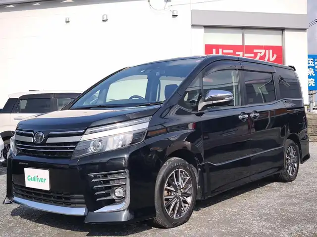 トヨタ ヴォクシー ZS 煌Ⅱ 熊本県 2016(平28)年 10万km ブラック 純正9インチナビ（NSZT-Y66T）/【フルセグTV/Bluetooth/CD/DVD/HDMI】/バックカメラ/純正12.1インチフリップダウンモニター/両側パワースライドドア/衝突被害軽減システム/車線逸脱警報/オートLEDヘッドライト/プッシュスタート/スマートキー/純正16インチAW/ドライブレコーダー/ETC/ウインカーミラー