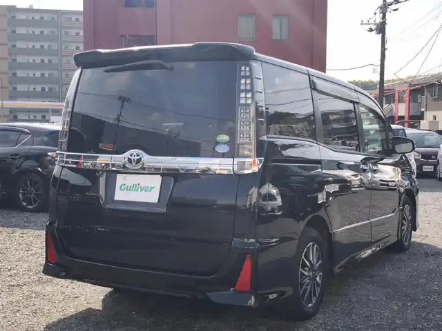 トヨタ ヴォクシー ZS 煌Ⅱ 熊本県 2016(平28)年 10万km ブラック 純正9インチナビ（NSZT-Y66T）/【フルセグTV/Bluetooth/CD/DVD/HDMI】/バックカメラ/純正12.1インチフリップダウンモニター/両側パワースライドドア/衝突被害軽減システム/車線逸脱警報/オートLEDヘッドライト/プッシュスタート/スマートキー/純正16インチAW/ドライブレコーダー/ETC/ウインカーミラー