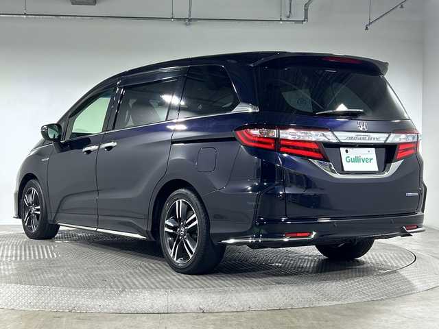 ホンダ オデッセイ ハイブリッド アブソルート ホンダセンシング 神奈川県 2016(平28)年 6.5万km プレミアムヴィーナスブラックP 純正８型SDナビゲーション【VXM-175VFNi】/フルセグ　CD DVD　SDMUSICRACK　AM FM/バックカメラ/両側電動スライドドア【サンシェード】/ホンダセンシング/衝突軽減ブレーキ/歩行者事故低減ステアリング/アダブティブクルーズコントロール/LKAS車線維持支援システム/路外逸脱抑制機能/誤発進抑制機能/先行車発進お知らせ機能/標識認識機能/前後ソナー/コンフォートビューパッケージ/ECON/EVモード/純正前方ドライブレコーダー/純正ビルトインETC/ブラックプライムスムース合皮/ファブリックコンビシート/運転席パワーシート/２列目オットマン/革巻きステアリング/プッシュスタート/スマートキー/LEDヘッドランプ/オートライト/フロントフォグランプ/純正リアスポイラー/純正17インチアルミホイール