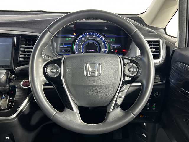 ホンダ オデッセイ ハイブリッド アブソルート ホンダセンシング 神奈川県 2016(平28)年 6.5万km プレミアムヴィーナスブラックP 純正８型SDナビゲーション【VXM-175VFNi】/フルセグ　CD DVD　SDMUSICRACK　AM FM/バックカメラ/両側電動スライドドア【サンシェード】/ホンダセンシング/衝突軽減ブレーキ/歩行者事故低減ステアリング/アダブティブクルーズコントロール/LKAS車線維持支援システム/路外逸脱抑制機能/誤発進抑制機能/先行車発進お知らせ機能/標識認識機能/前後ソナー/コンフォートビューパッケージ/ECON/EVモード/純正前方ドライブレコーダー/純正ビルトインETC/ブラックプライムスムース合皮/ファブリックコンビシート/運転席パワーシート/２列目オットマン/革巻きステアリング/プッシュスタート/スマートキー/LEDヘッドランプ/オートライト/フロントフォグランプ/純正リアスポイラー/純正17インチアルミホイール