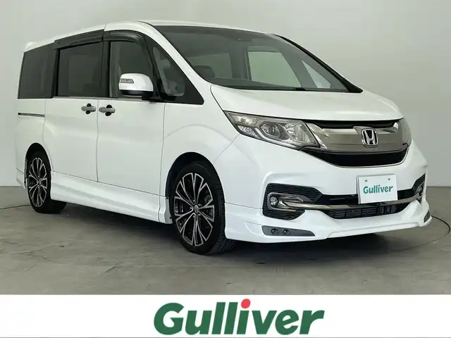 ホンダ ステップワゴン スパーダ クルスピセンシング 大分県 2015(平27)年 6.2万km ホワイトオーキッドパール 純正9インチインターナビ/フルセグTV/ーDISC/ーBluetooth/バックカメラ/ハーフレザー/両側パワースライドドア/ホンダセンシング/衝突軽減ブレーキ/先行車発進お知らせ機能/ACC先行車検知音/標識認識機能/路外逸脱抑制システム/LEDヘッドライト/無限エアロ/純正フリップダウンモニター/レーダークルーズコントロール/オートライト/純正16インチアルミホイール/純正フロアマット/ＥＴＣ/ドライブレコーダー/前席シートヒーター/横滑り防止装置