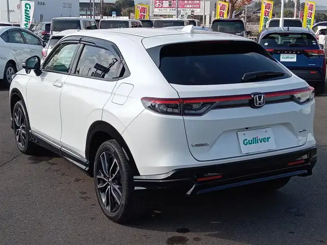 ホンダ ヴェゼル ハイブリッド e:HEV Z 福井県 2021(令3)年 1.9万km プラチナホワイトパール 純正9インチナビ/AM/FM/フルセグ/BT/USB/バックカメラ/無限エアロ/アダプティブクルーズコントロール/前後コーナーセンサー/衝突被害軽減システム/BSM/レーンキープアシスト/横滑り防止装置/ETC２．０/ワイヤレス充電/前後ドライブレコーダー/SOSボタン/前席シートヒーター/オートブレーキホールド/ハーフレザーシート/ステアリングヒーター/電動リアゲート/純正フロアマット/パドルシフト/純正18インチAW/LEDヘッドライト/スマートキー