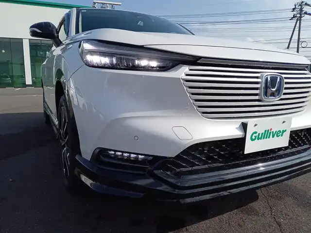 ホンダ ヴェゼル ハイブリッド e:HEV Z 福井県 2021(令3)年 1.9万km プラチナホワイトパール 純正9インチナビ/AM/FM/フルセグ/BT/USB/バックカメラ/無限エアロ/アダプティブクルーズコントロール/前後コーナーセンサー/衝突被害軽減システム/BSM/レーンキープアシスト/横滑り防止装置/ETC２．０/ワイヤレス充電/前後ドライブレコーダー/SOSボタン/前席シートヒーター/オートブレーキホールド/ハーフレザーシート/ステアリングヒーター/電動リアゲート/純正フロアマット/パドルシフト/純正18インチAW/LEDヘッドライト/スマートキー