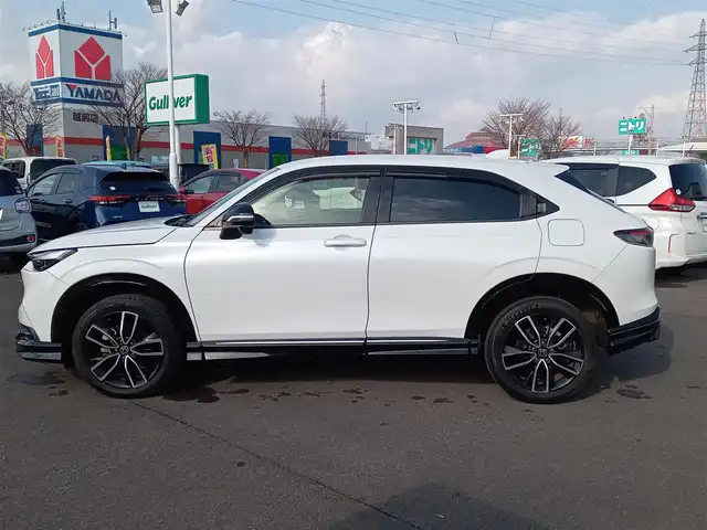 ホンダ ヴェゼル ハイブリッド e:HEV Z 福井県 2021(令3)年 1.9万km プラチナホワイトパール 純正9インチナビ/AM/FM/フルセグ/BT/USB/バックカメラ/無限エアロ/アダプティブクルーズコントロール/前後コーナーセンサー/衝突被害軽減システム/BSM/レーンキープアシスト/横滑り防止装置/ETC２．０/ワイヤレス充電/前後ドライブレコーダー/SOSボタン/前席シートヒーター/オートブレーキホールド/ハーフレザーシート/ステアリングヒーター/電動リアゲート/純正フロアマット/パドルシフト/純正18インチAW/LEDヘッドライト/スマートキー