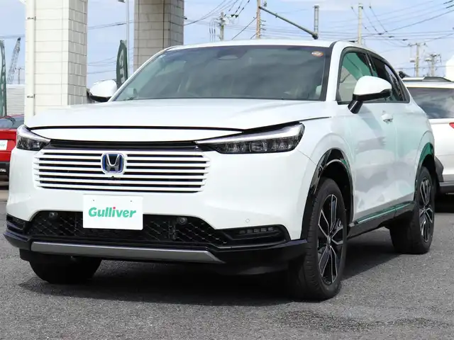 ホンダ ヴェゼル ハイブリッド e:HEV Z 神奈川県 2025(令7)年 0.1千km プラチナホワイトパール ワンオーナー/Honda SENSING/ブラインドスポットインフォメーション/アダプティブドライビングビーム(ADB)/後退出庫サポート/Honda CONNECTディスプレー＋ETC2.0車載器＋ワイヤレス充電器/運転席助手席シートヒーター/ハンズフリーアクセスパワーテールゲート(予約クローズ機能付)/LEDシーケンシャルターンシグナルランプ/マルチビューカメラシステム＋プレミアムオーディオ/18インチアルミホイール/コンビシート/本革巻きステアリング/保証書/取説、ナビ説/スペアスマートキー