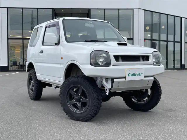 スズキ ジムニー XG 青森県 2009(平21)年 5万km スペリアホワイト ・４ＷＤ/・５速マニュアル車/・社外オーディオ/　AM/FM/CD/・社外ツィーター/・ＥＴＣ/・リフトアップ/・社外フロアマット/・ドアバイザー/・リモコンキー/・１５インチ社外ＡＷ付スタッドレスタイヤ積込/　175/80/R16 5mm