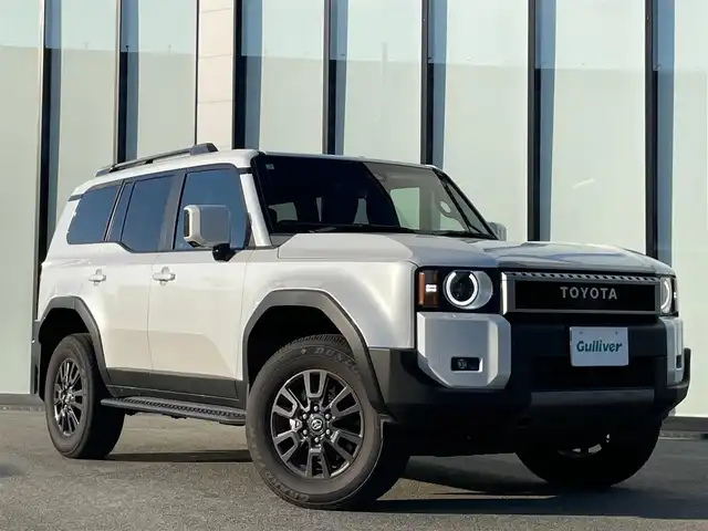 トヨタ ランドクルーザー ２５０ VX 大阪府 2025(令7)年 0.5万km プラチナホワイトパールマイカ 純正１２．３インチナビ　/　 フルセグＴＶ/Bluetooth/USB　/全方位モニター/サンルーフ/衝突軽減ブレーキ　/クリアランスソナー/ブラインドスポットモニター　/スマートルームミラー　/前席シートヒーター、ベンチレーション/レーダークルーズコントロール/アイドリングストップ/センターデフロック　/電動リアゲート　/運転席パワーシート/オートマチックハイビーム/純正18インチアルミホイール/純正フロアマット/プッシュスタート/スマートキー　/ビルトインＥＴＣ2.0　/ＬＥＤライト