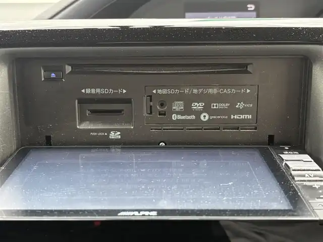 トヨタ ヴォクシー ハイブリッド V 愛知県 2014(平26)年 16.5万km ブラッキッシュアゲハガラスフレーク ワンオーナー/バックカメラ/社外SDナビ/Bluetooth/SD/DVD/CD/社外後席モニター/フルセグTV/3列シート/両側パワースライドドア/クルーズコントロール/ビルトインETC/シートヒーター/置くだけ充電/純正フロアマット/純正アルミホイール/LEDヘッドライト/スペアキー/保証書/取扱説明書