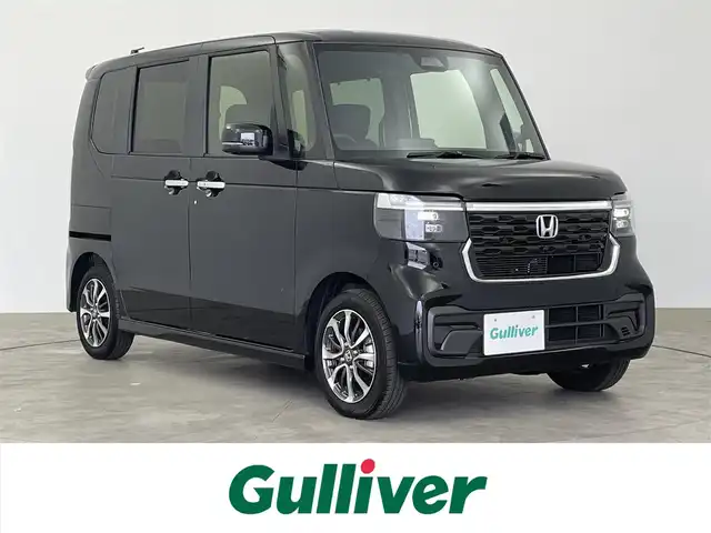 ホンダ Ｎ ＢＯＸ カスタム 大分県 2024(令6)年 0.1万km クリスタルブラックパール 社外7インチディスプレイオーディオ /ホンダセンシング/・衝突軽減ブレーキ（CMBS）/・車線維持支援システム（LKAS）/・アダプティブクルーズコントロール（ACC）/・後方誤発進抑制機能/・誤発進抑制機能/片側パワースライドドア/右イージークローザードア/前席シートヒーター/LEDヘッドライト/ウインカーミラー/コーナーセンサー/純正14インチアルミホイル/サイド/カーテンエアバッグ/スマートキー