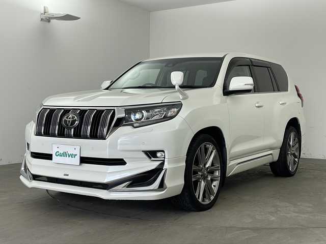 トヨタ ランドクルーザー プラド TX Lパッケージ 兵庫県 2019(平31)年 5万km ホワイトパールクリスタルシャイン ・社外9インチナビ/Bluetooth/CD/DVD/TV/・バックカメラ/・トヨタセーフティセンス/・プリクラッシュセーフティ/・レーンディパーチャーアラート/・オートマチックハイビーム/・レーダークルーズコントロール/・クリアランスソナー/・センターデフロック/・ダウンヒルアシストコントロール/・ローダウン/・オートサイドステップ/・革シート/・前席パワーシート/・前席シートヒーター/・前席ベンチレーション/・モデリスタエアロ/・22インチアルミホイールタイヤ/・LEDヘッドライト/・フォグランプ/・ビルトインETC/・スマートキー