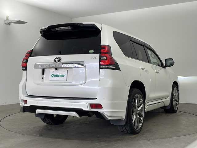 トヨタ ランドクルーザー プラド TX Lパッケージ 兵庫県 2019(平31)年 5万km ホワイトパールクリスタルシャイン ・社外9インチナビ/Bluetooth/CD/DVD/TV/・バックカメラ/・トヨタセーフティセンス/・プリクラッシュセーフティ/・レーンディパーチャーアラート/・オートマチックハイビーム/・レーダークルーズコントロール/・クリアランスソナー/・センターデフロック/・ダウンヒルアシストコントロール/・ローダウン/・オートサイドステップ/・革シート/・前席パワーシート/・前席シートヒーター/・前席ベンチレーション/・モデリスタエアロ/・22インチアルミホイールタイヤ/・LEDヘッドライト/・フォグランプ/・ビルトインETC/・スマートキー
