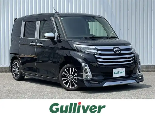 トヨタ ルーミー カスタムG－T 福岡県 2024(令6)年 0.8万km ブラックマイカメタリック モデリスタエアロ/スマートアシスト搭載/レーンキープアシスト/純正9インチディスプレイオーディオ/（BT/USB/FM/AM/AppleCarplay/AndroidAuto）/全周囲カメラ/ビルトインETC２．０/ステアリングスイッチ/ドライブレコーダー前後/社外デジタルインナーミラー/両側パワースライドドア/電動パーキングブレーキ/コーナーセンサー前後/純正フロアマット/純正アルミホイール/LEDライト/プッシュスタート/スマートキー/取扱説明書