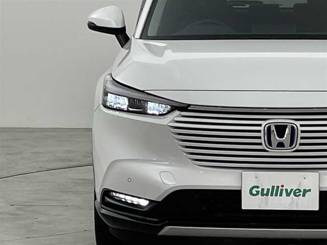 ホンダ ヴェゼル ハイブリッド e:HEV Z 福岡県 2021(令3)年 6.4万km プラチナホワイトパール 純正ナビ（フルセグＴＶ）　/バックカメラ　/ＥＴＣ　/前後ドラレコ　/ＡＣＣ　/コーナーセンサー　/衝突被害軽減ブレーキ　/レーンキープ　/ＢＳＭ　/アクセル踏み間違い防止　/パドルシフト　/パワーバックドア　/ハーフレザー