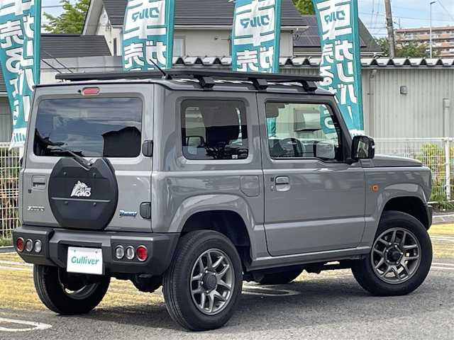 スズキ ジムニー XC 宮城県 2022(令4)年 1.4万km ミディアムグレー /社外メモリナビ//CD/DVD/SD/BT/HDMI/フルセグテレビ//バックカメラ//クルーズコントロール//ETC//社外ドライブレコーダー前後//シートヒーター前席//衝突被害軽減ブレーキ//レーンキープアシスト//ルーフキャリア//背面タイヤカバー（純正背面タイヤ有り）//社外16インチアルミスタッドレスタイヤ積込//スマートキーx2
