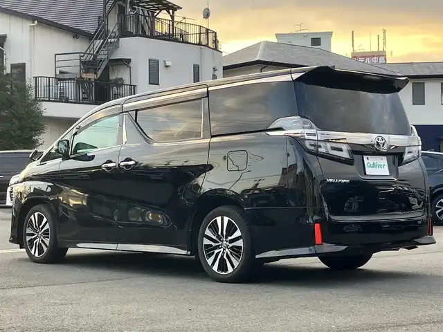 トヨタ ヴェルファイア Z Gエディション 静岡県 2021(令3)年 1.1万km ブラック 純正9インチナビ（CD/DVD/BT）/バックカメラ/エンジンスタートボタン/パワーステアリング/パワーウィンドウ/保証書/取扱説明書/スマートキー/Wオートエアコン/レーダークルーズコントロール/12.1インチ後席モニター/USB入力端子/ETC/三列シート/N席電動オットマン/電動リアゲート/ドライブレコーダー前後/フロアマット/D席N席パワーシート/合皮シート/D席N席シートヒーター/D席N席エアシート/両側パワースライドドア/純正アルミホイール/ABS/横滑り防止装置/コーナーセンサー前後/レーンキープアシスト/盗難防止装置/オートライト/オートマチックハイビーム/三眼LEDヘッドライト/W+サイドエアバッグ/カーテンエアバッグ/衝突軽減システム/ステアリングヒーター/二列目電動リクライニング/二列目電動オットマン/三列目ヘッドレスト１つ不足
