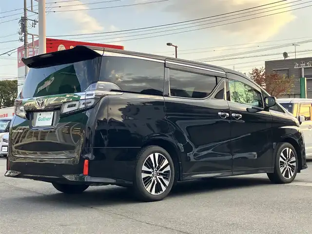 トヨタ ヴェルファイア Z Gエディション 静岡県 2021(令3)年 1.1万km ブラック 純正9インチナビ（CD/DVD/BT）/バックカメラ/エンジンスタートボタン/パワーステアリング/パワーウィンドウ/保証書/取扱説明書/スマートキー/Wオートエアコン/レーダークルーズコントロール/12.1インチ後席モニター/USB入力端子/ETC/三列シート/N席電動オットマン/電動リアゲート/ドライブレコーダー前後/フロアマット/D席N席パワーシート/合皮シート/D席N席シートヒーター/D席N席エアシート/両側パワースライドドア/純正アルミホイール/ABS/横滑り防止装置/コーナーセンサー前後/レーンキープアシスト/盗難防止装置/オートライト/オートマチックハイビーム/三眼LEDヘッドライト/W+サイドエアバッグ/カーテンエアバッグ/衝突軽減システム/ステアリングヒーター/二列目電動リクライニング/二列目電動オットマン/三列目ヘッドレスト１つ不足