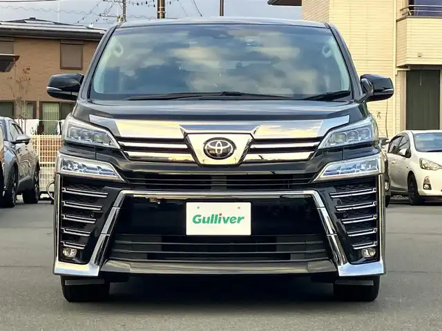 トヨタ ヴェルファイア Z Gエディション 静岡県 2021(令3)年 1.1万km ブラック 純正9インチナビ（CD/DVD/BT）/バックカメラ/エンジンスタートボタン/パワーステアリング/パワーウィンドウ/保証書/取扱説明書/スマートキー/Wオートエアコン/レーダークルーズコントロール/12.1インチ後席モニター/USB入力端子/ETC/三列シート/N席電動オットマン/電動リアゲート/ドライブレコーダー前後/フロアマット/D席N席パワーシート/合皮シート/D席N席シートヒーター/D席N席エアシート/両側パワースライドドア/純正アルミホイール/ABS/横滑り防止装置/コーナーセンサー前後/レーンキープアシスト/盗難防止装置/オートライト/オートマチックハイビーム/三眼LEDヘッドライト/W+サイドエアバッグ/カーテンエアバッグ/衝突軽減システム/ステアリングヒーター/二列目電動リクライニング/二列目電動オットマン/三列目ヘッドレスト１つ不足