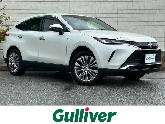 トヨタ ハリアー ハイブリッド Z レザーパッケージ 滋賀県 2021(令3)年 6.4万km ホワイトパールクリスタルシャイン JBLプレミアムサウンド/純正１２．３インチナビ/（AM/FM/TVフルセグ/Bluetooth/USB/Miracasyt）/デジタルインナーミラー/ドライブレコーダー前後/Toyota Safety Sense/・プリクラッシュセーフティ/・レーントレーシングアシスト/・ロードサインアシスト/パノラミックビューモニター/ブラインドスポットモニター/ETC2.0/シートヒーターD/N/シートベンチレーションD/N/電動リアゲート/横滑り防止装置/パワーシートD/N/シートメモリー/ヘッドアップディスプレイ/レザーシート/電子パーキング/ブレーキホールド/EV MODE/ステアリングヒーター/ステアリングスイッチ/オートライト/LEDヘッドライト/フロントフォグ/純正ドアバイザー/電動格納ミラー/オートエアコン/スマートキー/プッシュスタート/スペアキー