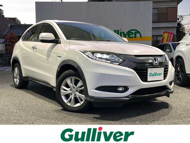 ホンダ ヴェゼル ハイブリッド X 東京都 2015(平27)年 9.7万km ホワイトオーキッドパール HDDナビ/バックカメラ/クルーズコントロール/パドルシフト/フルセグテレビ/BT/SD/CD/DVD/USB/AUX/HDMI/ETC/横滑り防止装置/純正アルミホイール/純正フロアマット/取扱説明書/保証書