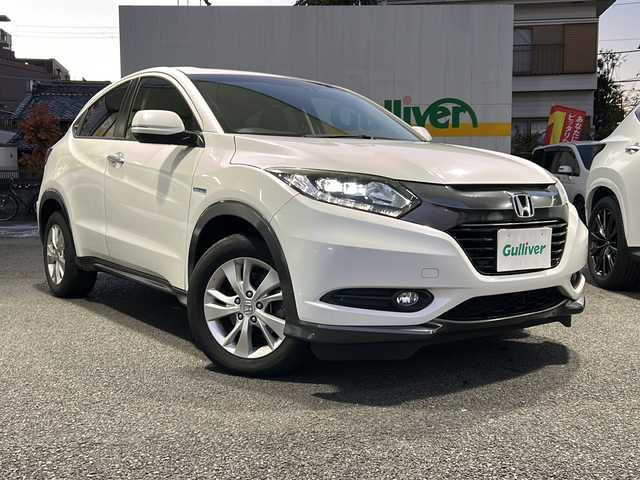 ホンダ ヴェゼル ハイブリッド X 東京都 2015(平27)年 9.7万km ホワイトオーキッドパール HDDナビ/バックカメラ/クルーズコントロール/パドルシフト/フルセグテレビ/BT/SD/CD/DVD/USB/AUX/HDMI/ETC/横滑り防止装置/純正アルミホイール/純正フロアマット/取扱説明書/保証書