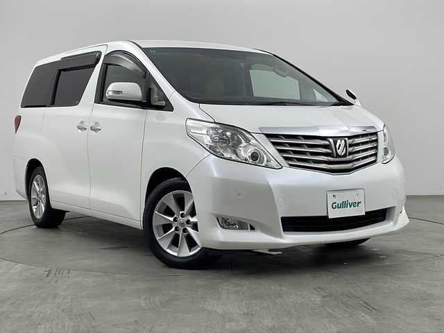 トヨタ アルファード 240G 兵庫県 2010(平22)年 8.1万km ホワイトパールクリスタルシャイン 純正7インチHDDナビ（NHZA-W66G）/CD/DVD/ワンセグ/BT/バックカメラ/ビルトインETC/純正フリップダウンモニター/クルーズコントロール/両側パワースライドドア/運転席・助手席パワーシート/レザー調シートカバー/ウッド調コンビステアリング/純正17インチアルミホイール/クリアランスソナー/プッシュスタート/スマートキー/オットマン/オートライト/ディスチャージヘッドライト