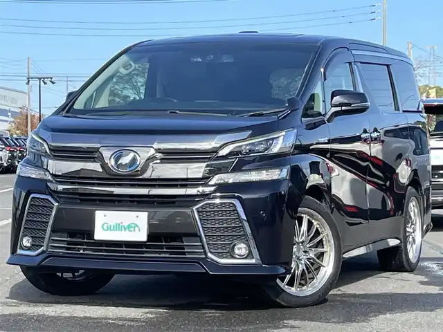 トヨタ ヴェルファイア ハイブリット ZR Gエディション 道央・札幌 2017(平29)年 9.2万km スパークリングブラックパールクリスタルシャイン ４WD/ワンオーナー/寒冷地仕様/純正ディーラーOPナビ/CD/DVD/BT/フルセグ/純正フリップダウンモニター/横滑り防止装置/クルーズコントロール/クリアランスソナー/バックカメラ/ビルトインETC/ドライブレコーダー/ワイパーデアイサー/EVMODE/ECOMODE/ツインサンルーフ/両側パワースライドドア/パワーバックドア/前席/２列目パワーシート/D席メモリーシート/前席シートヒーター/N席/２列目オットマン/レザーシート/革巻きステアリング/ステアリングリモコン/ハンドルヒーター/AC100V/電動パーキング/ブレーキホールド/MTモード付AT/自動防眩ミラー/プッシュスタート/純正リモートスタート/スマートキー/LEDヘッドライト/オートライト/オートハイビーム/フォグランプ/電動格納ミラー/ウィンカーミラー/純正フロアマット/ドアバイザー/スペアキー