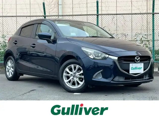 マツダ デミオ 13S Lパッケージ 東京都 2015(平27)年 2.7万km ディープクリスタルブルーマイカ マツダ純正ナビ/・BT/AM/FM/SD/バックビューモニター/ＵＳＢ入力端子/ドライブモード/純正フロアマット/純正ドアバイザー/アイドリングストップ/純正アルミ/コーナーセンサー/横滑り制御機能/プッシュスタート /スマートキー