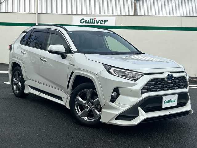 トヨタ ＲＡＶ４ ハイブリットG 東京都 2020(令2)年 5.7万km ホワイトパールクリスタルシャイン ワンオーナー/レザーシート/4WD/純正SDナビ（NSZT-Y68T）/・Bluetooth/TV/CD/DVD/SD/Toyota Safety Sense/・プリクラッシュセーフティ/・レーントレーシングアシスト/・レーダークルーズコントロール/・オートマチックハイビーム/・ロードサインアシスト/先行車発進告知機能/インテリジェントクリアランスソナー/リヤクロストラフィックオートブレーキ/ブラインドスポットモニター/横滑り防止装置/盗難防止装置/ドライブレコーダー/バックカメラ/オートライト/オートマチックハイビーム/オートエアコン/電動格納ミラー/プッシュスタート/電動リアゲート/コーナーセンサー/純正18インチアルミホイール/TRD製エアロパーツセット/TRD製オーバーフェンダー/ETC/スペアキー1本/取扱説明書