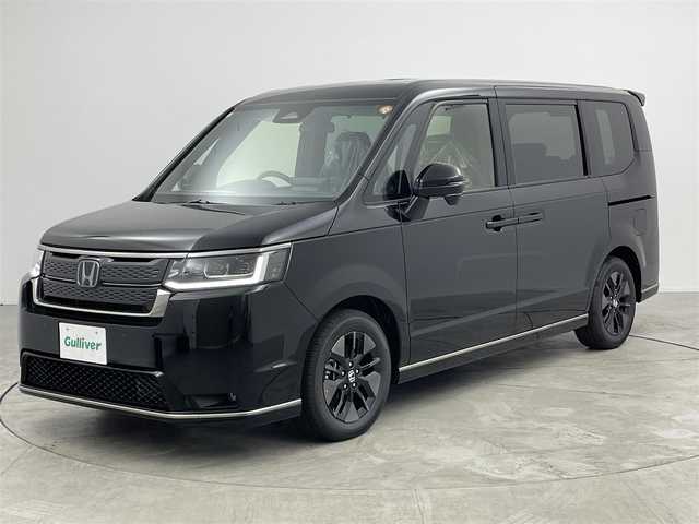 ホンダ ステップワゴン スパーダ eHEV 愛知県 2025(令7)年 0.1万km未満 黒 登録済み未使用車/ホンダセンシング/　・衝突軽減ブレーキ/　・誤発進抑制機能/　・後方誤発進抑制機能/　・近距離衝突軽減ブレーキ/　・歩行者事故低減ステアリング/　・路外越脱抑制機能/　・アダプティブクルーズコントロール/　・車線維持支援システム/　・トラフィックジャムアシスト/　・先行発進知らせ機能/　・標識認識機能/　・オートハイビーム/ホンダパーソナルアシスト/純正11.4インチHONDA　CONNECTナビ/　（Bluetooth/CD/Apple CarPlay/）/バックカメラ/ディライト/ハーフレザー/シートヒーター/本革ステアリング/シートバックテーブル/両側パワースライドドア/電動リアゲード/3列目格納シート/純正LEDライト/コーナリングライト/パドルシフト/オットマン
