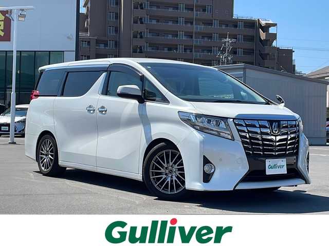 トヨタ アルファード X 山形県 2017(平29)年 10.7万km ホワイトパールクリスタルシャイン 衝突軽減ブレーキ/横滑り防止装置/ALPINE9インチナビ【X9Z】/(CD/DVD/フルセグTV/BT)/ALPINEフリップダウンモニター/バックカメラ/ビルトインETC/アダプティブクルーズコントロール/両側パワースライドドア/ドライブレコーダー/革巻きステアリング/ステアリングスイッチ/電動パーキングブレーキ/ブレーキホールド/レザー調シートカバー/電動格納ミラー/フロアマット/スマートキー×２