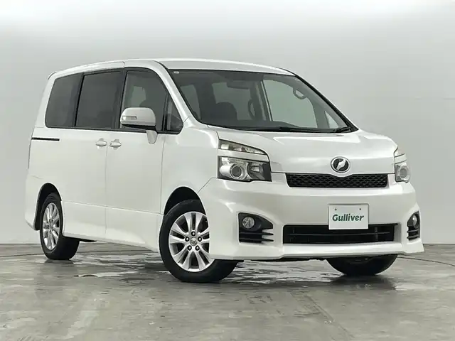トヨタ ヴォクシー ZS 福島県 2010(平22)年 13.3万km ホワイトパールクリスタルシャイン 盗難防止装置/社外7インチナビ/・型番：NS2T-W60/・フルセグ/TV/BT/SD/AUX/CD/DVD/AM/FM/・バックカメラ/ETC/フリップダウンモニター/革巻ステアリング/・ステアリングリモコン/・パドルシフト/3列シート/・チップアップシート/片側パワースライドドア/LEDヘッドライト/・フォグランプ/・オートライト/プッシュスタート/・スマートキー/純正17インチAW/純正フロアマット