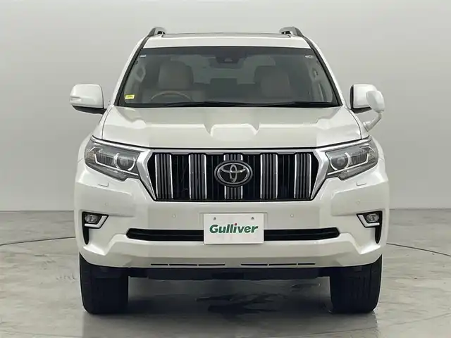 トヨタ ランドクルーザー プラド TX Lパッケージ 福岡県 2023(令5)年 1.4万km ホワイトパールクリスタルシャイン サンルーフ　/純正ナビ　/バックカメラ　/ビルトインＥＴＣ　/レーダークルコン　/コーナーセンサー　/衝突軽減ブレーキ　/レーンキープ　/踏み間違い防止/先行車発進お知らせ　/ＭＴモード付き　/ベージュ本革　/シートベンチレーション／ヒーター　/ステアリングリモコン　/パワーシート　/ルーフレール