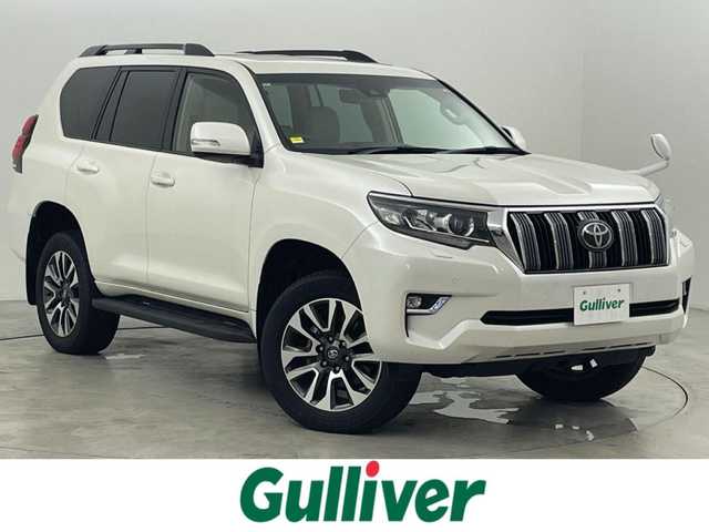 トヨタ ランドクルーザー プラド TX Lパッケージ 福岡県 2023(令5)年 1.4万km ホワイトパールクリスタルシャイン サンルーフ　/純正ナビ　/バックカメラ　/ビルトインＥＴＣ　/レーダークルコン　/コーナーセンサー　/衝突軽減ブレーキ　/レーンキープ　/踏み間違い防止/先行車発進お知らせ　/ＭＴモード付き　/ベージュ本革　/シートベンチレーション／ヒーター　/ステアリングリモコン　/パワーシート　/ルーフレール