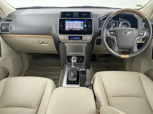 トヨタ ランドクルーザー プラド TX Lパッケージ 福岡県 2023(令5)年 1.4万km ホワイトパールクリスタルシャイン サンルーフ　/純正ナビ　/バックカメラ　/ビルトインＥＴＣ　/レーダークルコン　/コーナーセンサー　/衝突軽減ブレーキ　/レーンキープ　/踏み間違い防止/先行車発進お知らせ　/ＭＴモード付き　/ベージュ本革　/シートベンチレーション／ヒーター　/ステアリングリモコン　/パワーシート　/ルーフレール