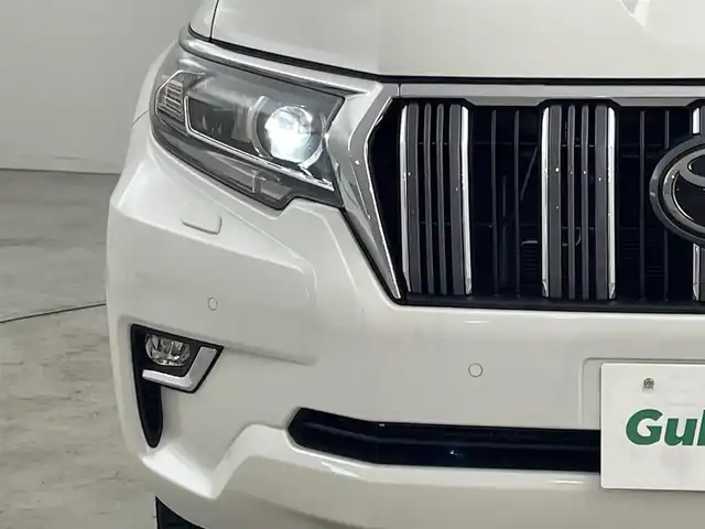 トヨタ ランドクルーザー プラド TX Lパッケージ 福岡県 2023(令5)年 1.4万km ホワイトパールクリスタルシャイン サンルーフ　/純正ナビ　/バックカメラ　/ビルトインＥＴＣ　/レーダークルコン　/コーナーセンサー　/衝突軽減ブレーキ　/レーンキープ　/踏み間違い防止/先行車発進お知らせ　/ＭＴモード付き　/ベージュ本革　/シートベンチレーション／ヒーター　/ステアリングリモコン　/パワーシート　/ルーフレール