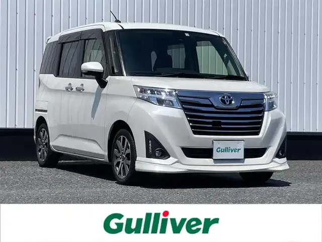 トヨタ ルーミー カスタムG－T 千葉県 2018(平30)年 2.1万km パールホワイトⅢ 純正9インチナビ/(フルセグTV/CD/DVD/BT/FM/AM)/バックカメラ/衝突被害軽減システム/クルーズコントロール/両側パワースライドドア/横滑り防止装置/アイドリングストップ/LEDヘッドライト/フォグランプ/オートライト/ウィンカーミラー/電動格納ミラー/純正15インチAW/シートリフター/プッシュスタート/スマートキー/フロアマット/スペアキー/取扱説明書/保証書