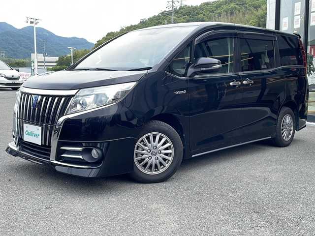 トヨタ エスクァイア ハイブリッド Gi 兵庫県 2015(平27)年 8万km ブラック 社外11型ナビ/・BT/・TV/・AM/FM/クルーズコントロール/前席シートヒーター/前後ドラレコ/ビルトインETC/ステアリングスイッチ/LEDライト/電格ミラー/置くだけ充電/純正フロアマット/ドアバイザー