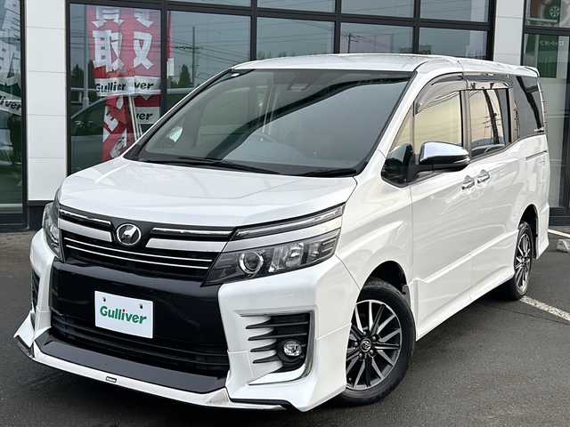 トヨタ ヴォクシー ZS 煌Ⅱ 道東・釧路十勝 2017(平29)年 11.5万km ホワイトパールクリスタルシャイン ・4WD/・純正9インチメモリナビ/（CD/DVD/BT/SD/USB）/・両側パワースライドドア/・バックカメラ/・純正12.9インチフリップダウンモニター/・モデリスタリップスポイラー/・ETC/・ドアバイザー/・アイドリングストップ/・LEDヘッドライト/・フォグランプ/・オートライト/・オートマチックハイビーム/・プッシュスタート/・スマートキー/・純正アルミホイール
