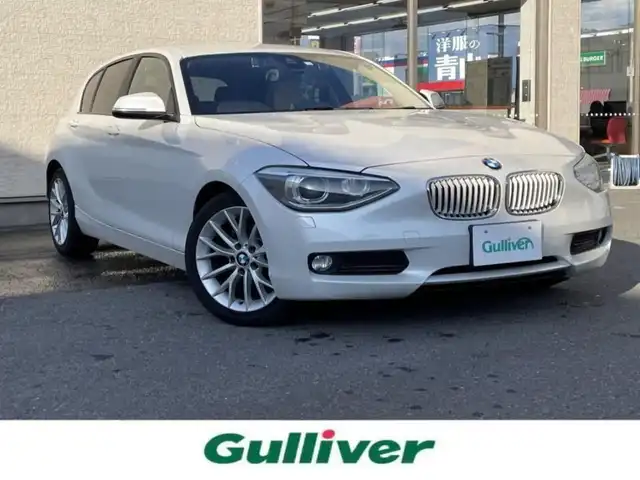 ＢＭＷ １１６ｉ ファッショニスタ 大阪府 2014(平26)年 9.4万km ミネラルホワイト 純正ナビ/　Bluetooth/CD/DVD/クルーズコントロール/レザーシート（ベージュ）/メモリ付きパワーシート/前席シートヒーター/電動リアゲート/バックカメラ/コーナーセンサー/ETC/保証書・取扱説明書