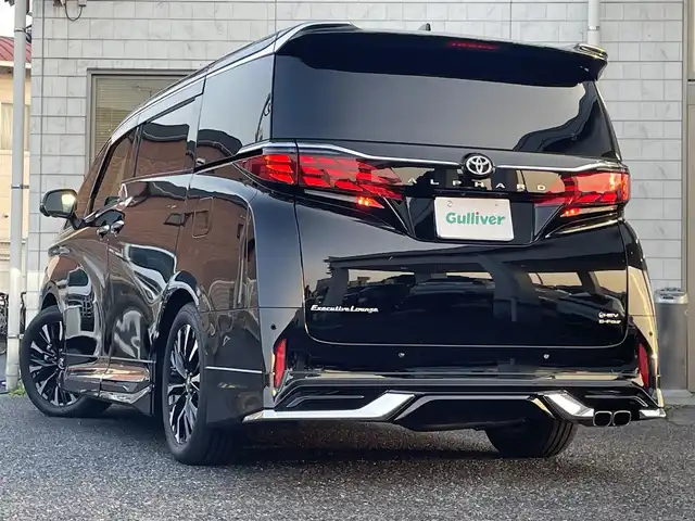 トヨタ アルファードハイブリット エグゼクティブ ラウンジ 福岡県 2025(令7)年 1.3万km ブラック ワンオーナー/モデリスタ/エアロ(フロント/サイド/リヤ)/マルチカラーインテリアイルミ/左右独立ムーンルーフ/純正14インチフリップダウンモニター/JBLサウンド/ユニバーサルステップ左右/デジタルインナーミラー/純正14インチコネクテッドナビ/(Bluetooth/Miracast/フルセグTV)/パノラミックビューモニター/トヨタチームメイト/アドバンストパーク/アドバンスドドライブ/トヨタセーフティセンス/プリクラッシュセーフティ/レーントディパーチャーアラート/レーンチェンジアシスト/レーダークルーズコントロール/ブラインドスポットモニター/安心降車アシスト/周辺車両接近時サポート/プロアクティブドライビングアシスト/フロント/リヤクロストラフィックアラート/リヤカメラディテクション/パワーバックドア/黒色レザーシート/ヘッドアップディスプレイ/ステアリングヒーター/パワーシート/シートヒーター/ベンチレーション(1.2列目)/シートメモリー/2列目/オットマン＆アームレストヒーター/リヤマルチオペレーションパネル/シート操作スイッチ/置くだけ充電