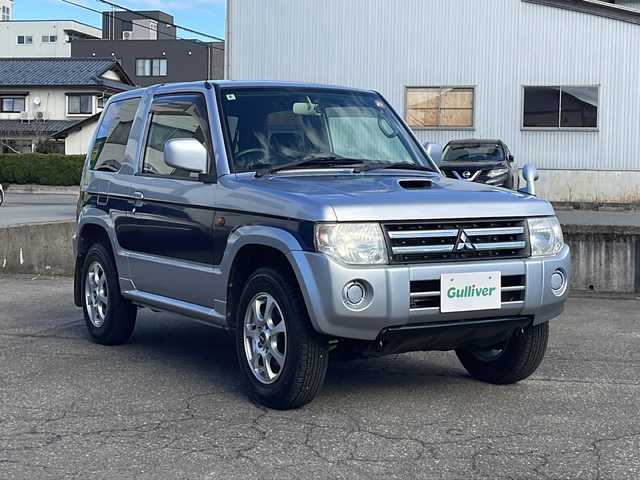 三菱 パジェロ ミニ VR 福井県 2010(平22)年 2.6万km クールシルバーM/ネアーズブルー 登録時走行距離25389ｋｍ/４WD/ターボ/ドライブレコーダー/背面タイヤ/社外15インチアルミホイール/キーレスキー/純正オーディオ/ライトレベライザー/ドアバイザー/電動格納ミラー/保証書/取扱説明書