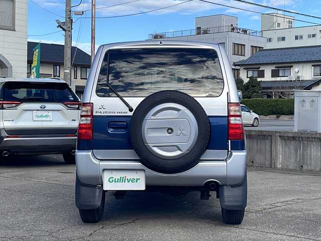 三菱 パジェロ ミニ VR 福井県 2010(平22)年 2.6万km クールシルバーM/ネアーズブルー 登録時走行距離25389ｋｍ/４WD/ターボ/ドライブレコーダー/背面タイヤ/社外15インチアルミホイール/キーレスキー/純正オーディオ/ライトレベライザー/ドアバイザー/電動格納ミラー/保証書/取扱説明書