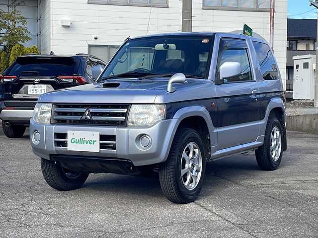 三菱 パジェロ ミニ VR 福井県 2010(平22)年 2.6万km クールシルバーM/ネアーズブルー 登録時走行距離25389ｋｍ/４WD/ターボ/ドライブレコーダー/背面タイヤ/社外15インチアルミホイール/キーレスキー/純正オーディオ/ライトレベライザー/ドアバイザー/電動格納ミラー/保証書/取扱説明書