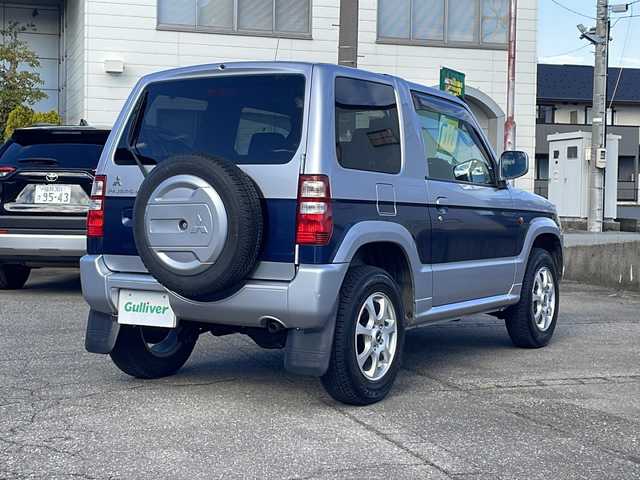 三菱 パジェロ ミニ VR 福井県 2010(平22)年 2.6万km クールシルバーM/ネアーズブルー 登録時走行距離25389ｋｍ/４WD/ターボ/ドライブレコーダー/背面タイヤ/社外15インチアルミホイール/キーレスキー/純正オーディオ/ライトレベライザー/ドアバイザー/電動格納ミラー/保証書/取扱説明書